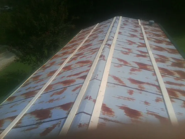 Rusted metal roof panels with new wood purlins before replacement — Storm Damage Roof Repair in Melcher Dallas by Roofing Brothers